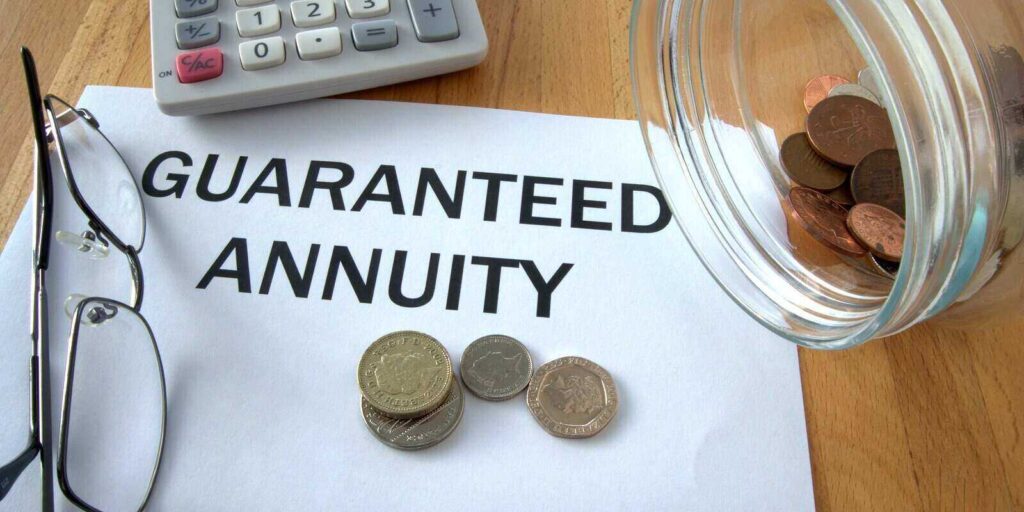 guaranteed annuity with coins on paper and in pot and calculator behind