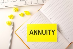 annuity text on sticker on diary with keyboard and pencil