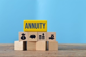 wooden blocks with text single premium deferred annuity and money symbols