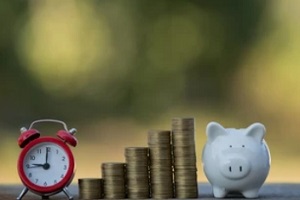 clock coin stack and piggy bank