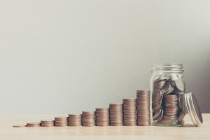 coin in glass bottle with money stack step up growing growth saving money