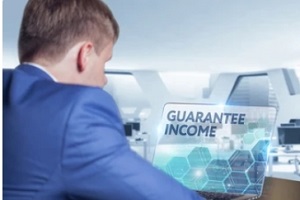 man checking guranteed income in laptop