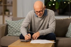 retired man doing calculation