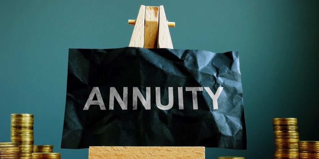annuity sign on the black sheet ans coins