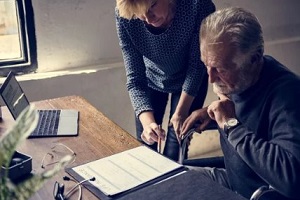 old man signing annuity bond