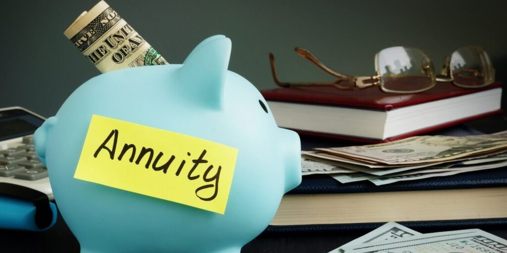 annuity written on yellow sheet and piggy bank with money