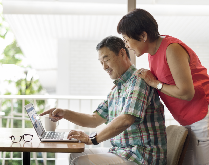 couple looking at computer in kitchen