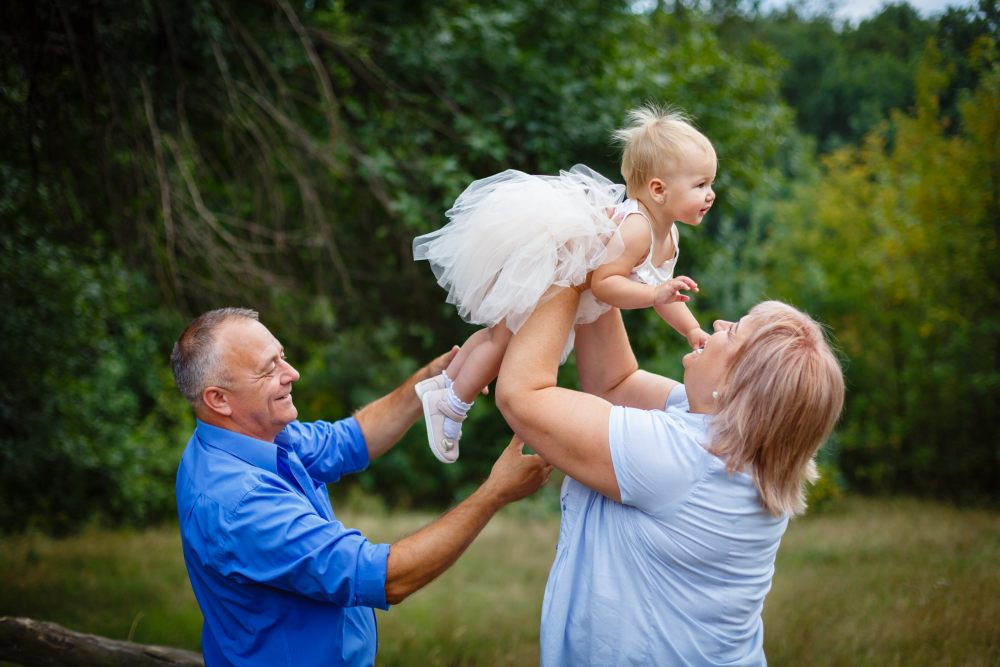 couple playing outside with grandkid