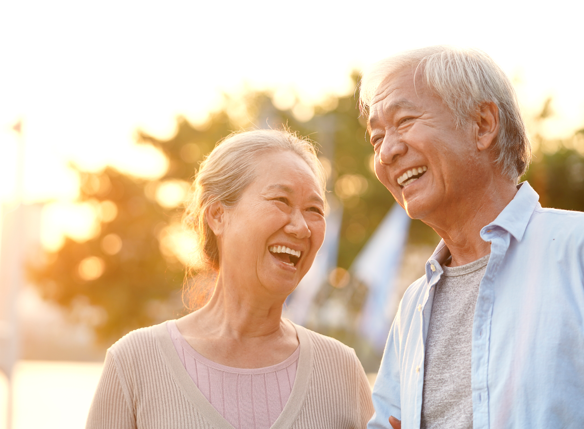 couple outside at sunset enjoying the weather smiling together