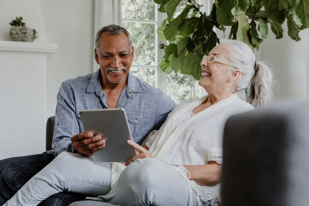 couple at home on couch looking up information