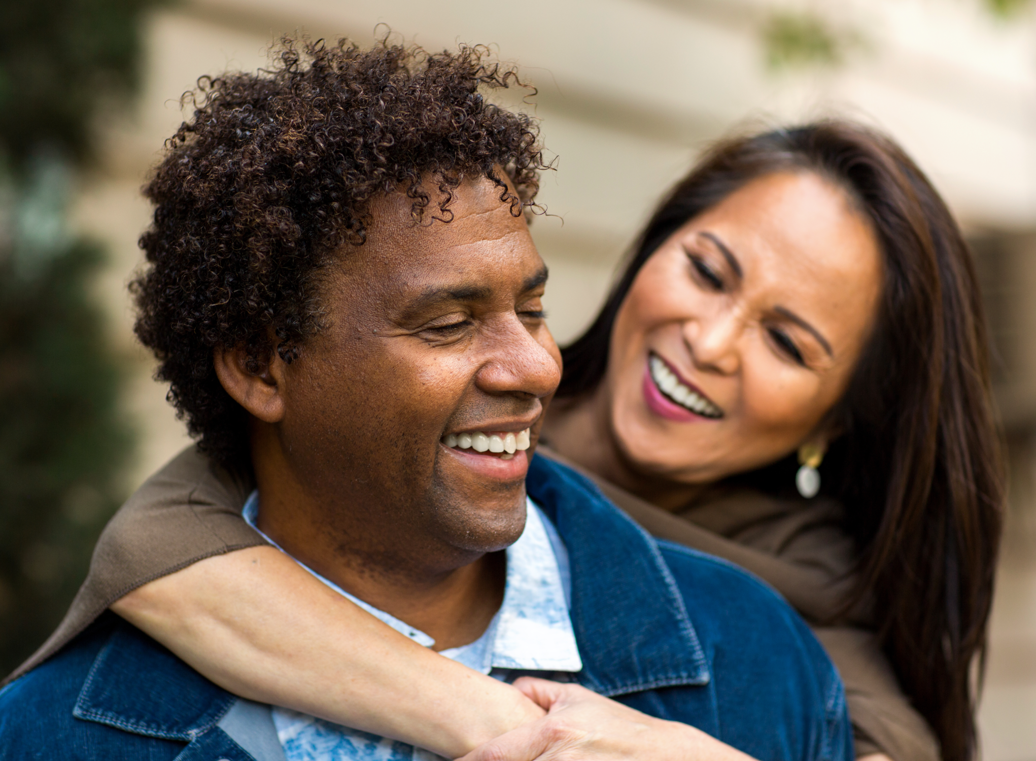 couple hugging and smiling outside