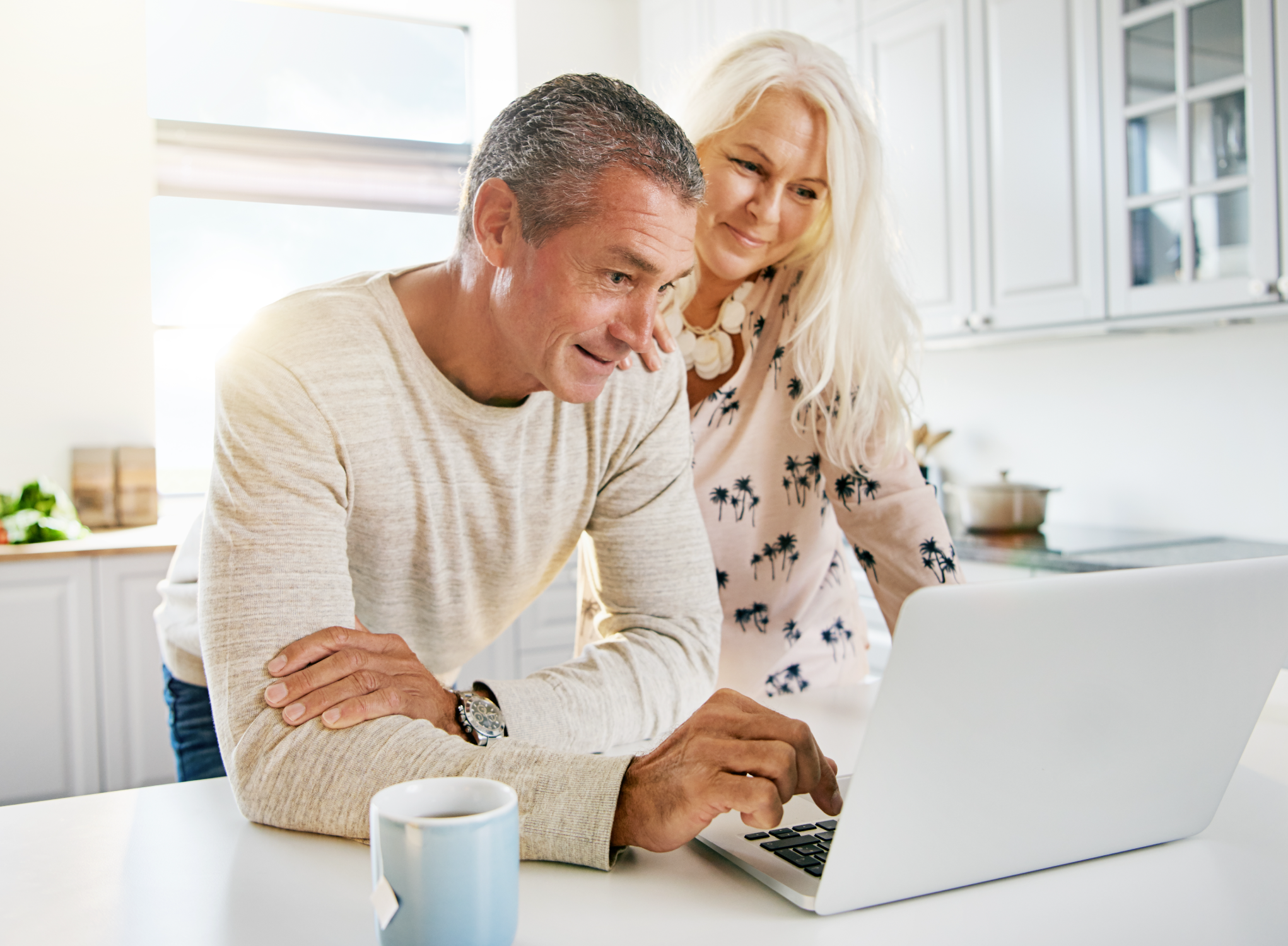 couple searching for MYGA on computer in kitched