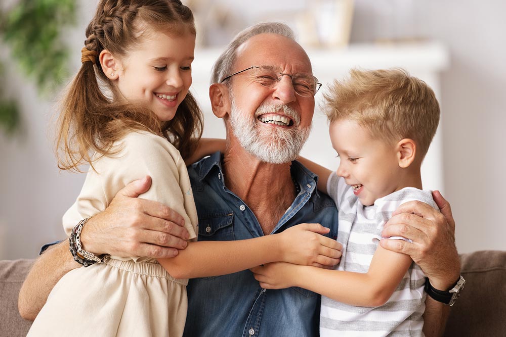 kids smiling with their grandfather