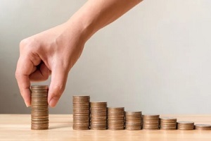 man holding coin sets growing