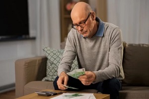 old man calculating money