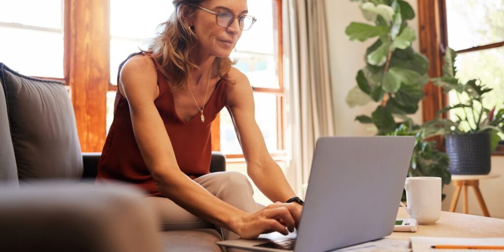 life insurance and senior woman on laptop for finance and investment planning during retirement at home