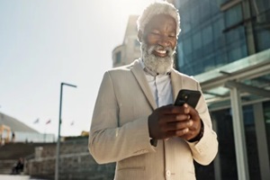 african person or employee with smartphone