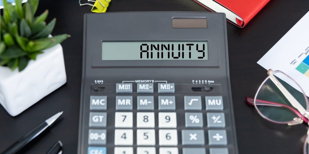 calculator with the word ANNUITY on display on an office worplace