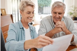 happy couple, reading and paperwork or document for bill, mortgage or retirement plan